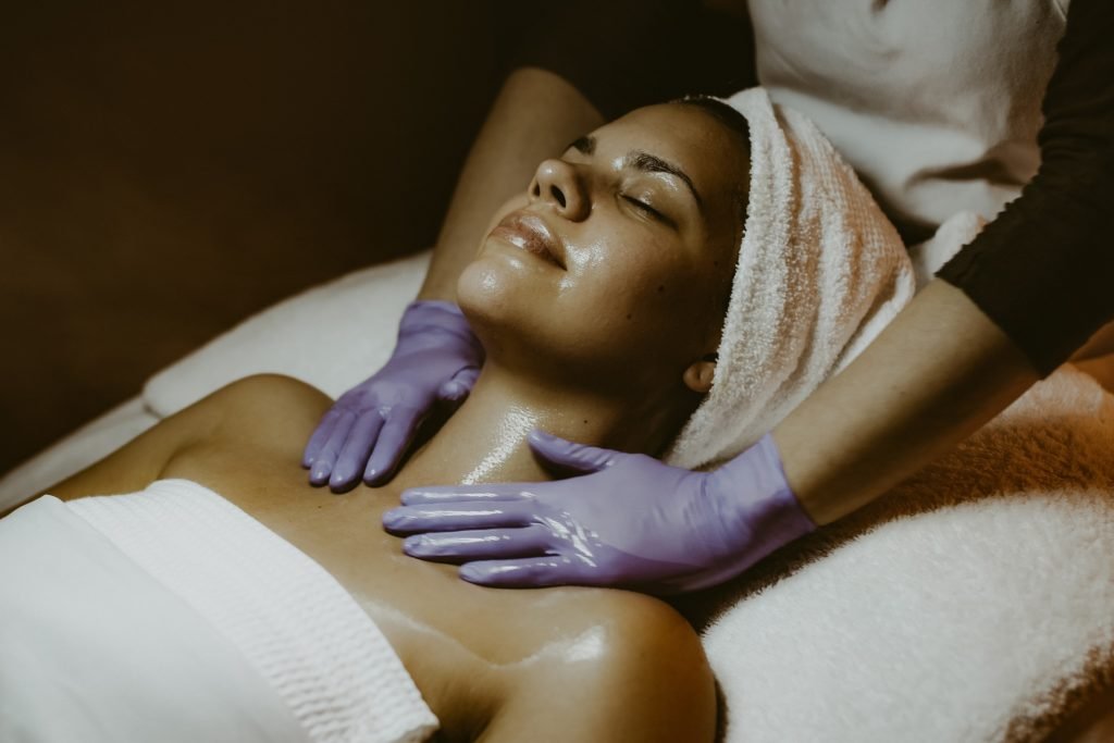 woman getting relaxation massage and a facial